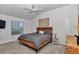 Comfortable bedroom with neutral decor, ceiling fan, and a large window at 6223 Atkinson Ln, The Villages, FL 32163