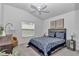 Cozy bedroom featuring a ceiling fan and a large window at 6223 Atkinson Ln, The Villages, FL 32163