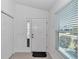Bright entryway with white walls, tile floors, and a closet, creating a clean and welcoming first impression at 6223 Atkinson Ln, The Villages, FL 32163