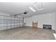 Open garage with ample lighting, a closed door and side mounted garage door opener at 6223 Atkinson Ln, The Villages, FL 32163