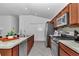 Kitchen featuring stainless steel appliances, granite counters and an island with stainless steel sink at 6223 Atkinson Ln, The Villages, FL 32163