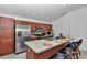 Kitchen area featuring stainless steel appliances, granite counters and an island with breakfast bar seating at 6223 Atkinson Ln, The Villages, FL 32163