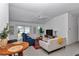 Open living room showcases ample natural light, ceiling fan, and modern decor at 6223 Atkinson Ln, The Villages, FL 32163