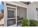 Cozy screened porch with comfortable seating, offering a perfect spot to relax and enjoy the outdoors at 6223 Atkinson Ln, The Villages, FL 32163