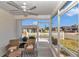 Inviting screened porch features ceiling fan and comfortable seating, providing a serene outdoor living space at 6223 Atkinson Ln, The Villages, FL 32163