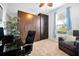 Bedroom with a large built-in closet, neutral carpet, a window with blinds and a sitting area at 634 Via Corso Ct, Kissimmee, FL 34759
