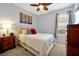 Cozy bedroom features a ceiling fan, picture window, carpeted floor and a queen size bed at 634 Via Corso Ct, Kissimmee, FL 34759