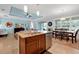 Open kitchen with a granite island, stainless steel appliances, and adjacent dining area at 634 Via Corso Ct, Kissimmee, FL 34759