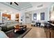 Open-concept living room flows into the kitchen with a cozy seating arrangement and stylish accents at 634 Via Corso Ct, Kissimmee, FL 34759