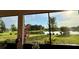 Relaxing screened patio view of the landscaped lawn and serene lake waters at 634 Via Corso Ct, Kissimmee, FL 34759