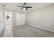 This bedroom features a ceiling fan, neutral walls, gray carpet, and a closet for storage at 641 Peachwood Dr, Altamonte Springs, FL 32714