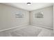 Bedroom featuring gray carpet and two windows, offering plenty of natural light at 641 Peachwood Dr, Altamonte Springs, FL 32714