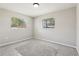 Bedroom featuring gray carpet and two windows, offering plenty of natural light at 641 Peachwood Dr, Altamonte Springs, FL 32714