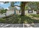 Charming single-story home with an eye catching front door, attractive landscaping, and mature trees at 641 Peachwood Dr, Altamonte Springs, FL 32714