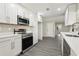Bright kitchen featuring stainless steel appliances, quartz countertops, and ample storage space at 641 Peachwood Dr, Altamonte Springs, FL 32714