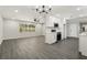 Modern kitchen boasts stainless steel appliances, white cabinets, and a seamless flow into the living area at 641 Peachwood Dr, Altamonte Springs, FL 32714