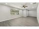 Spacious living room boasts wood floors, natural light, and a ceiling fan for added comfort at 641 Peachwood Dr, Altamonte Springs, FL 32714