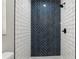 Shower with white subway tile and a vertical navy blue accent wall with herringbone pattern at 641 Peachwood Dr, Altamonte Springs, FL 32714
