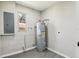 Utility room featuring a water heater, electrical panel, and wood-look vinyl flooring at 641 Peachwood Dr, Altamonte Springs, FL 32714