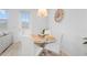 Bright dining area features a modern glass table with white chairs, perfect for meals at 733 Longboat Dr, Davenport, FL 33896