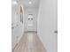 Bright entryway with wood floors, a white door, and modern decor at 733 Longboat Dr, Davenport, FL 33896