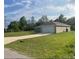 A single-story home featuring a two-car garage, driveway, and well-maintained lawn at 74 Malauka Pass, Ocklawaha, FL 32179
