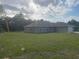 Single story house with light colored stucco, a 2 car garage, and a green lawn at 74 Malauka Pass, Ocklawaha, FL 32179