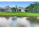 Tranquil backyard view with pond, lush lawn and the back of the home at 9942 Sweetleaf St, Orlando, FL 32827