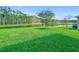 Manicured backyard featuring a lush lawn and picturesque pond at 9942 Sweetleaf St, Orlando, FL 32827