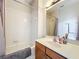 Bathroom features a shower-tub combo, wood cabinet and a sink at 9942 Sweetleaf St, Orlando, FL 32827