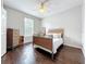 Bright bedroom showcasing hardwood floors, a ceiling fan, and natural light at 9942 Sweetleaf St, Orlando, FL 32827