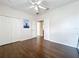 Bright bedroom features wood floors, ceiling fan and a double door closet at 9942 Sweetleaf St, Orlando, FL 32827