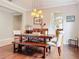 Dining room featuring hardwood floors, modern lighting, and an archway leading to the kitchen at 9942 Sweetleaf St, Orlando, FL 32827