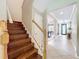Welcoming entryway with hardwood stairs, tiled floors, and plenty of natural light at 9942 Sweetleaf St, Orlando, FL 32827
