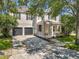 Charming two-story home featuring a welcoming front porch, dark shutters, and a spacious driveway and two-car garage at 9942 Sweetleaf St, Orlando, FL 32827