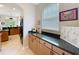 Hallway with tile floors, granite counters, wood cabinets and view to kitchen at 9942 Sweetleaf St, Orlando, FL 32827