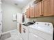 Functional laundry room with a washer, dryer, cabinets, and utility sink at 9942 Sweetleaf St, Orlando, FL 32827