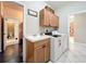 Well-equipped laundry room with appliances, storage cabinets, and a utility sink at 9942 Sweetleaf St, Orlando, FL 32827