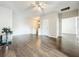Open living space with hardwood floors, ceiling fan, and staircase at 9942 Sweetleaf St, Orlando, FL 32827