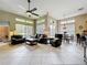 Open living room with ceiling fan, tile floors, and dining area with water view at 9942 Sweetleaf St, Orlando, FL 32827