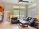 Open living room with ceiling fan, tile floors, and water view through sliding glass doors at 9942 Sweetleaf St, Orlando, FL 32827