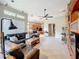 Open living room with tile floors, fireplace, and view to kitchen and dining areas at 9942 Sweetleaf St, Orlando, FL 32827