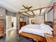This spacious main bedroom features a four-poster bed and hardwood floors at 9942 Sweetleaf St, Orlando, FL 32827
