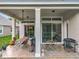 Covered patio with ceiling fan, patio dining set, and outdoor grill at 9942 Sweetleaf St, Orlando, FL 32827