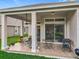 Covered patio with ceiling fan, patio dining set, and outdoor grill at 9942 Sweetleaf St, Orlando, FL 32827