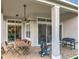 Covered patio with ceiling fan, patio dining set, and outdoor grill at 9942 Sweetleaf St, Orlando, FL 32827
