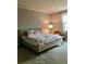 Cozy bedroom with a comfortable bed, soft lighting, and minimalist decor at 15708 Orange Harvest Loop, Winter Garden, FL 34787