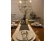 Elegantly set dining room table with fine china, glassware, and decorative centerpieces at 15708 Orange Harvest Loop, Winter Garden, FL 34787