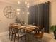 Chic dining area with a modern chandelier, dining table set for six, and stylish seating at 15708 Orange Harvest Loop, Winter Garden, FL 34787