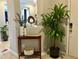 Stylish entryway featuring a console table, decorative plants, and modern decor at 15708 Orange Harvest Loop, Winter Garden, FL 34787